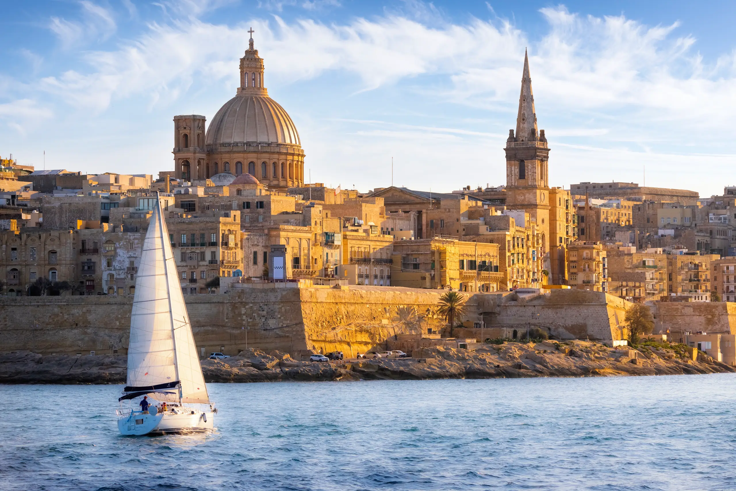 Honey-coloured stone harbour buildings in Valletta, a dialysis holiday destination in Malta